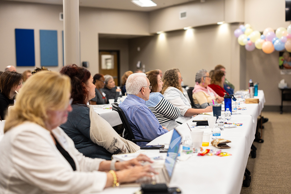 Attendees of Little Light House church conference watching a presenation